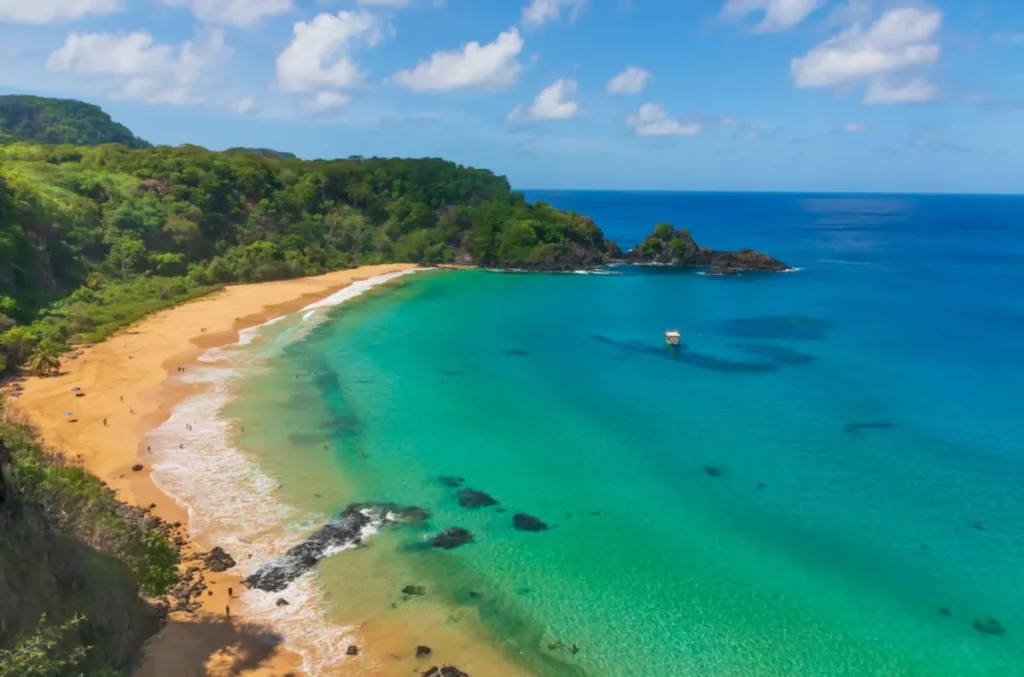Praia do Sancho com mar cristalino e areia dourada em Fernando de Noronha.