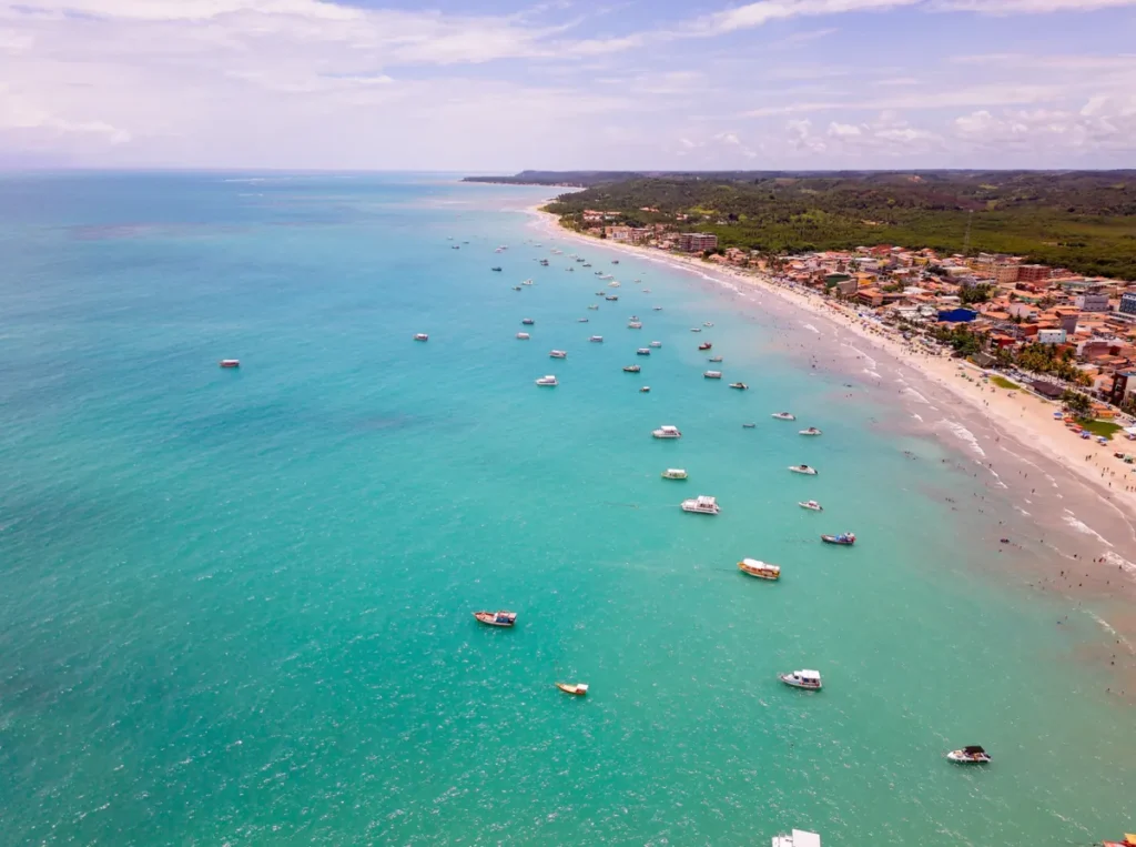Jangada navegando ao lado de recifes em águas cristalinas de Maragogi