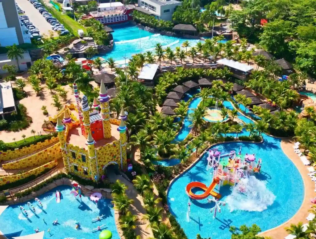 Complexo de piscinas e toboáguas cercado por áreas verdes no São Pedro Thermas Resort.
