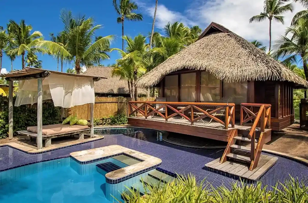 Bangalô do Nannai Muro Alto com piscina privativa, deck de madeira e área de descanso em meio à vegetação tropical.